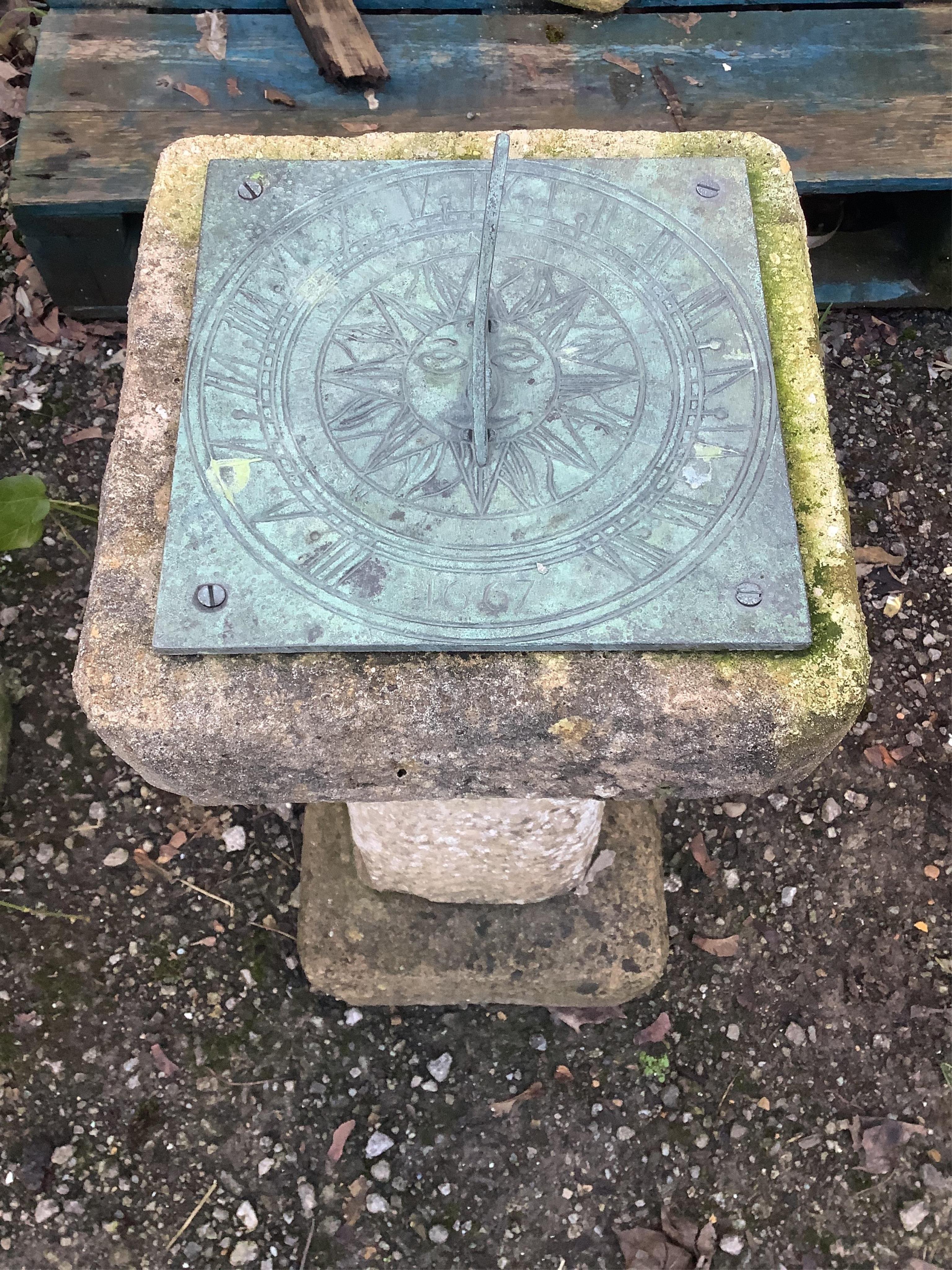 A cast metal sun dial on reconstituted stone base, height 70cm. Condition - fair